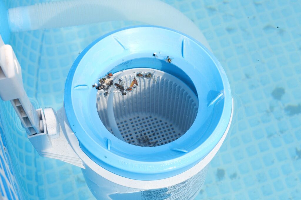 Top view of the blue skimmer for cleaning the pool in clear water Contaminated pool cleaning concept